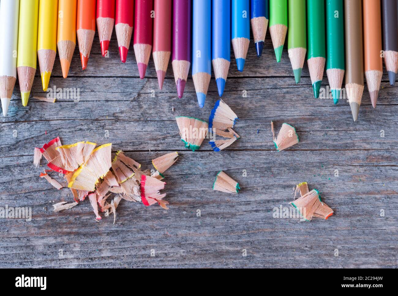 Creativity: Multi-colored pencils on rustic wooden table Stock Photo
