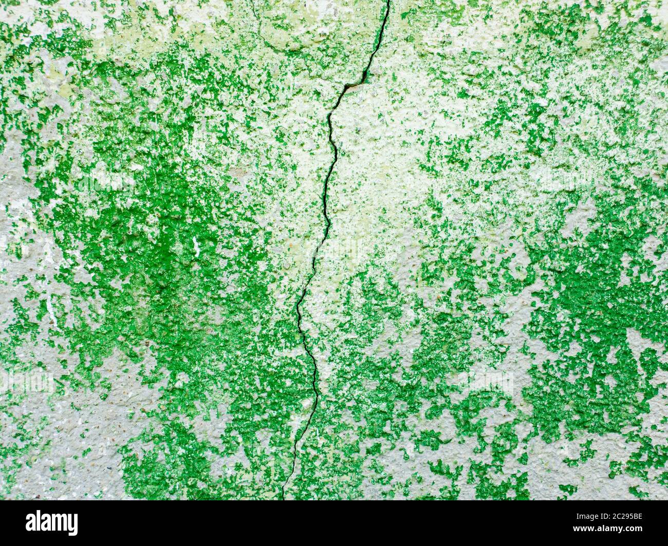 Split abstract surface cracked in the middle as green paint peeling off
