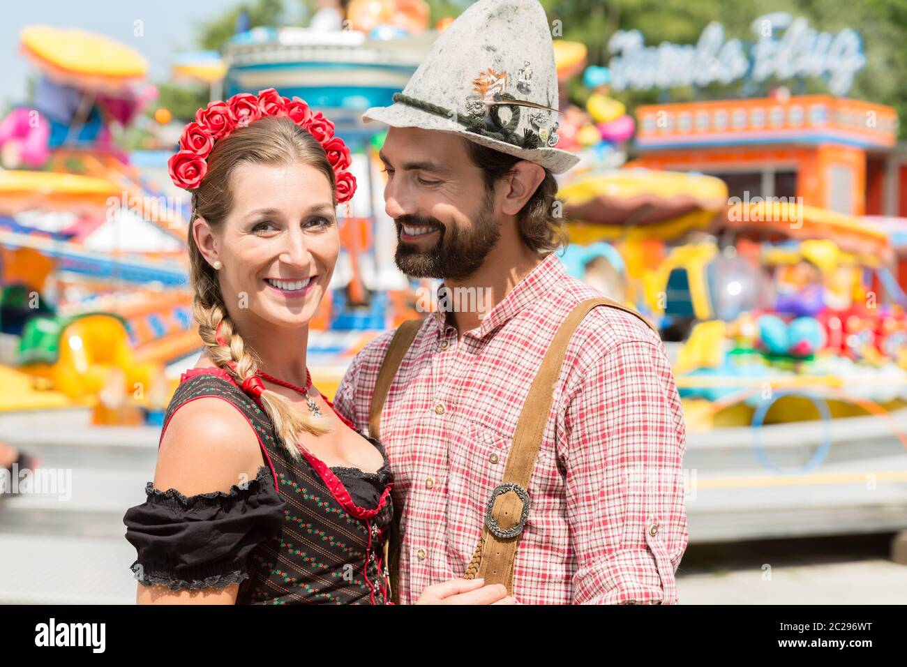 Couple having fun on Bavarian fair or Oktoberfest, man and woman Stock Photo