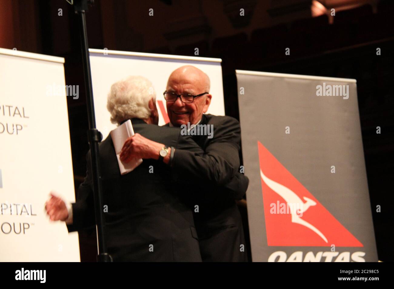 Co-founder of Westfield Group, Frank Lowy welcomes Rupert Murdoch to the stage with a hug to deliver the tenth anniversary Lowy Lecture at Sydney Town Stock Photo