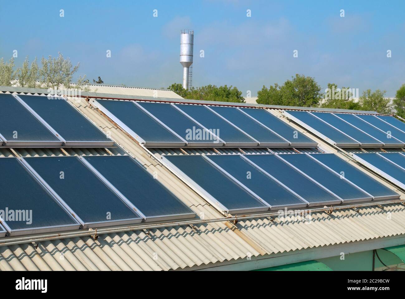 Solar water heating system on the red roof. Gelio panels. Stock Photo