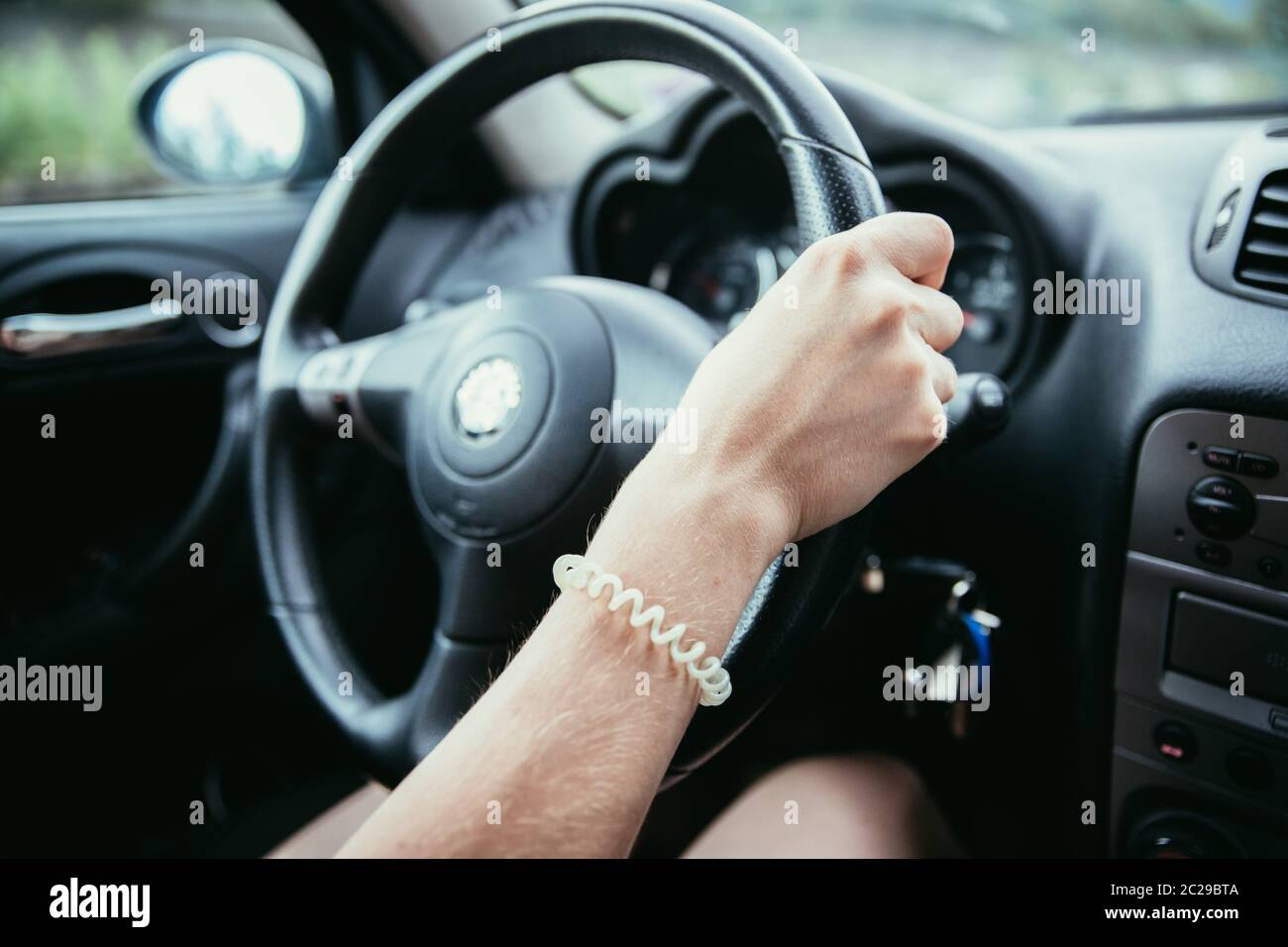 Sports car steering wheel, woman is driving Stock Photo Alamy