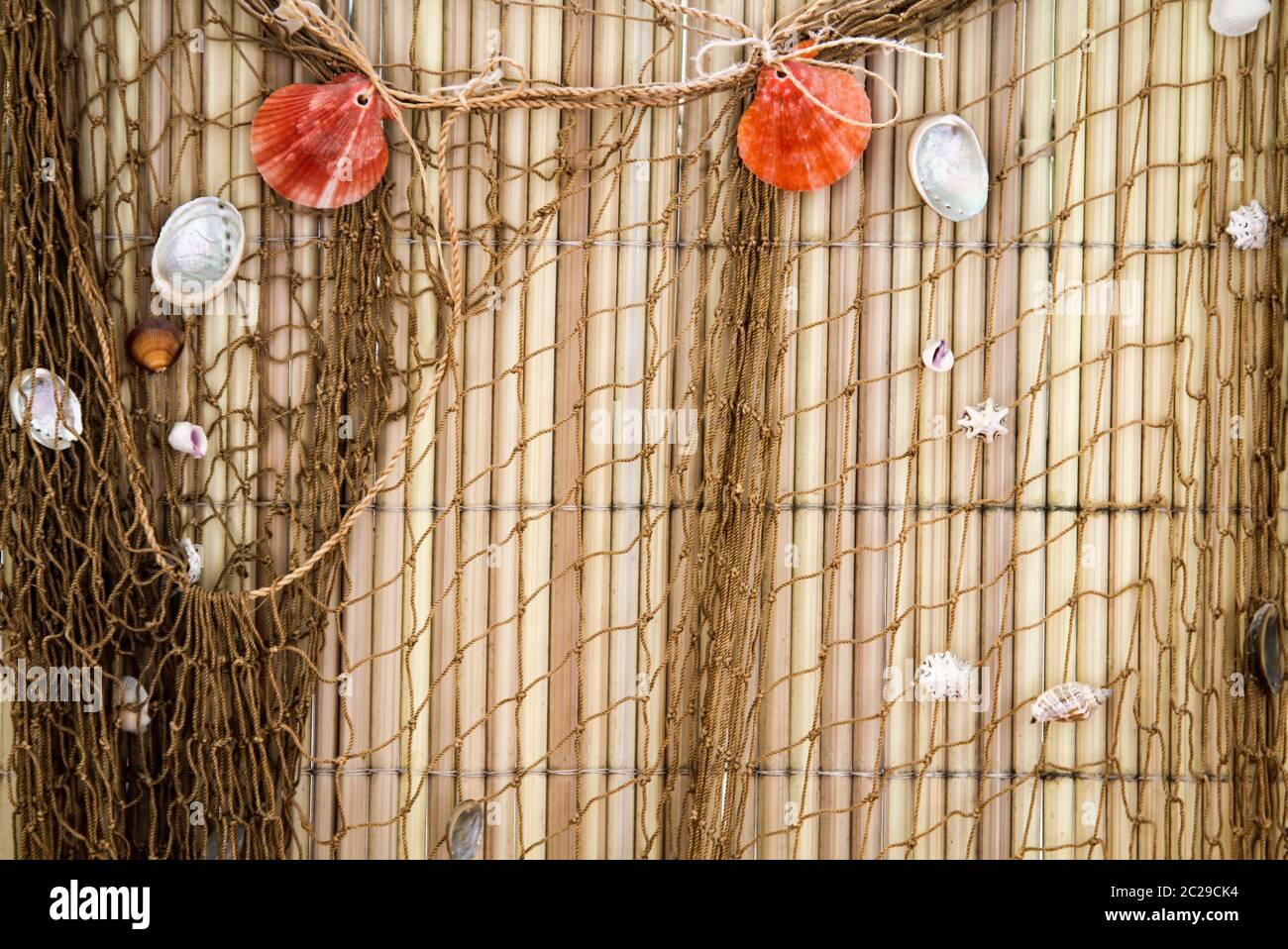 Fishing net with shells and reeds for decoration Stock Photo - Alamy