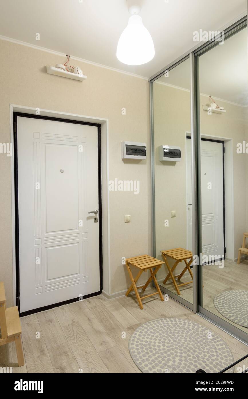 Hallway interior, large fitted wardrobe with large mirrors on the doors