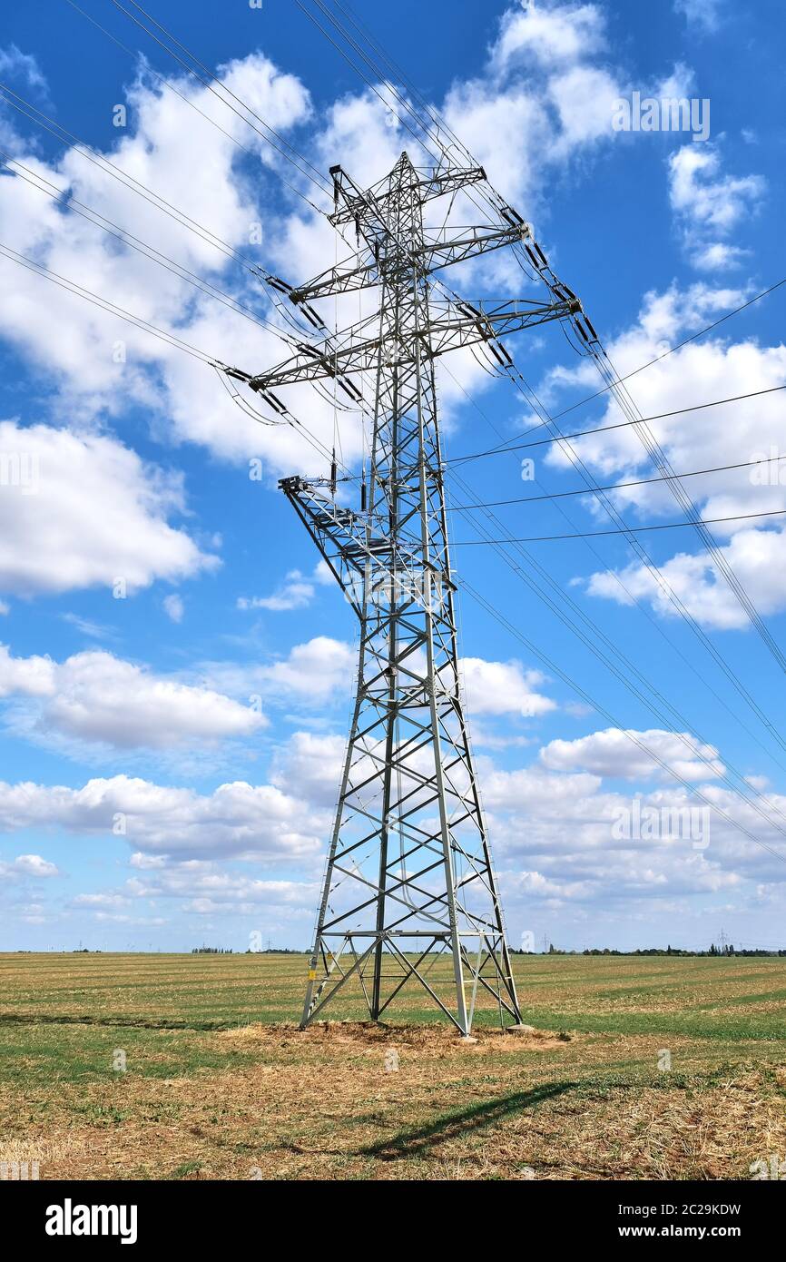 An electricity pylon with medium voltage power lines seen in Germany Stock Photo