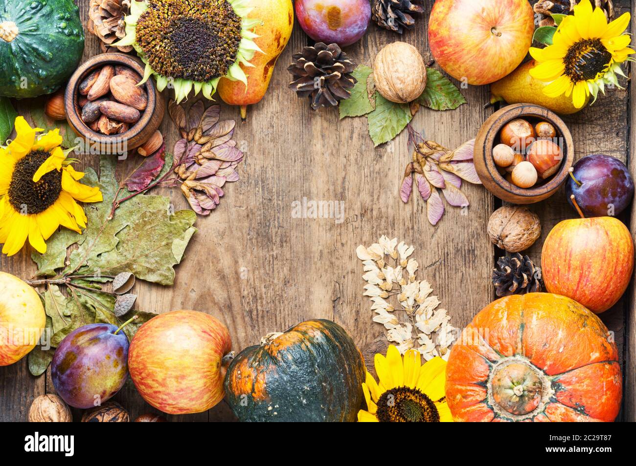 Pumpkins,nut and fruits in autumn still life on wooden table.Fall still ...