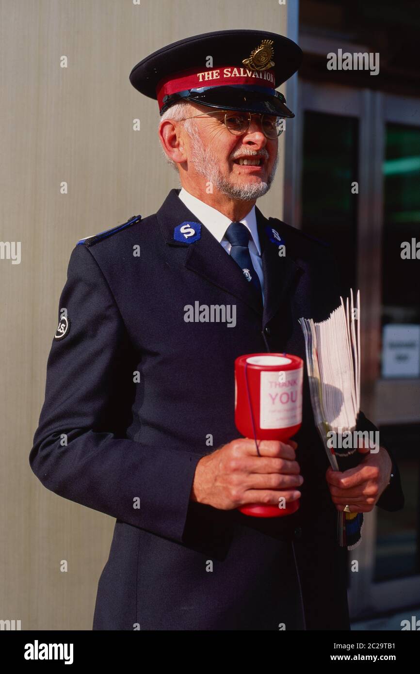 A gentleman from the Salvation Army selling copies of their magazine 'War Cry' in Clacton on Sea. Stock Photo