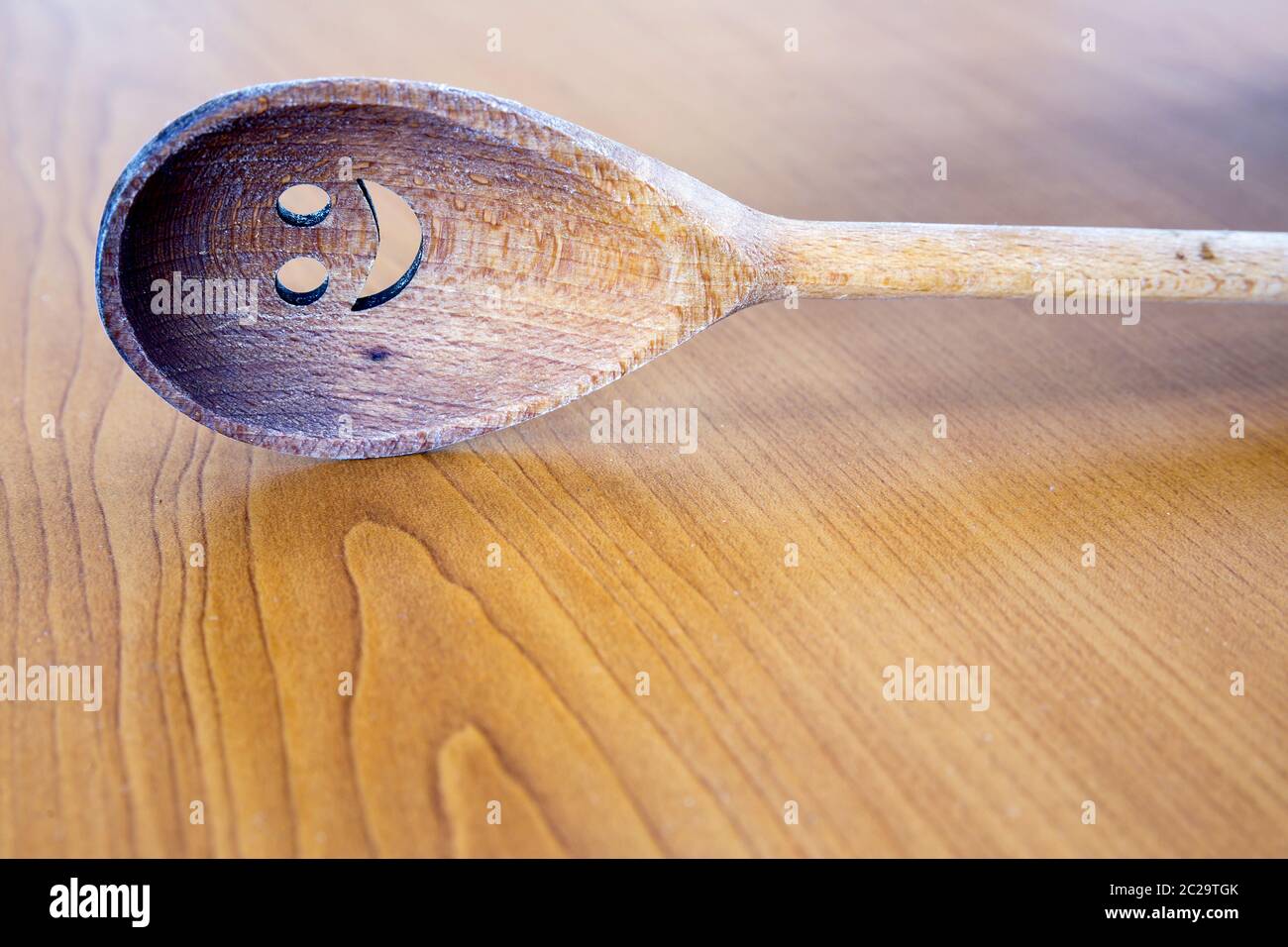 Wooden smiley face spoon on wooden background Stock Photo - Alamy