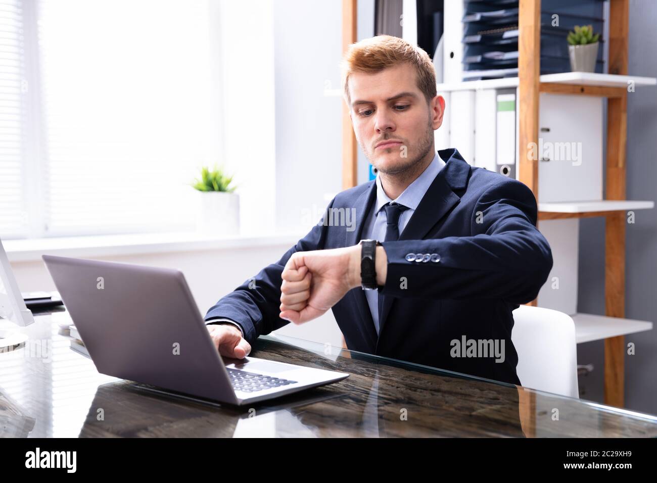 Efficient Businessman Looking At Watch Checking Time Stock Photo
