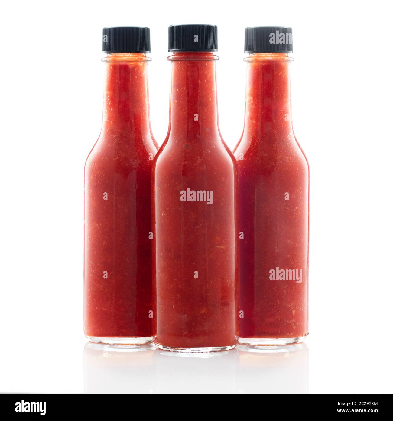 Three bottles of hot sauce without lables isolated on a white