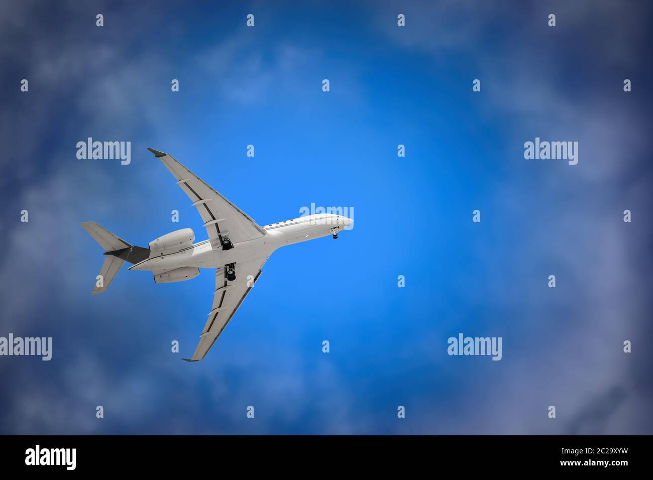 White Plane with Landing Gear in the Sky Stock Photo