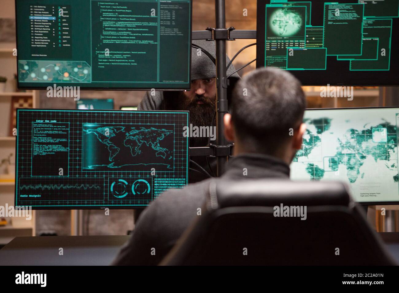 Two male hackers hacking into bank to steal credit card identity. Hackers technology. Stock Photo