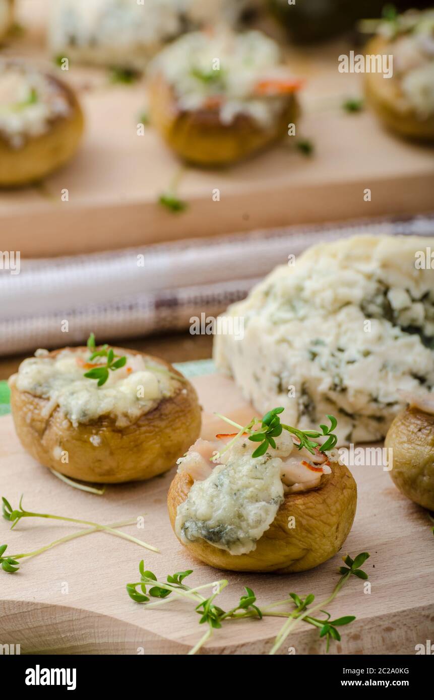 Mushrooms stuffed with blue cheese, microgreens on top, simple
