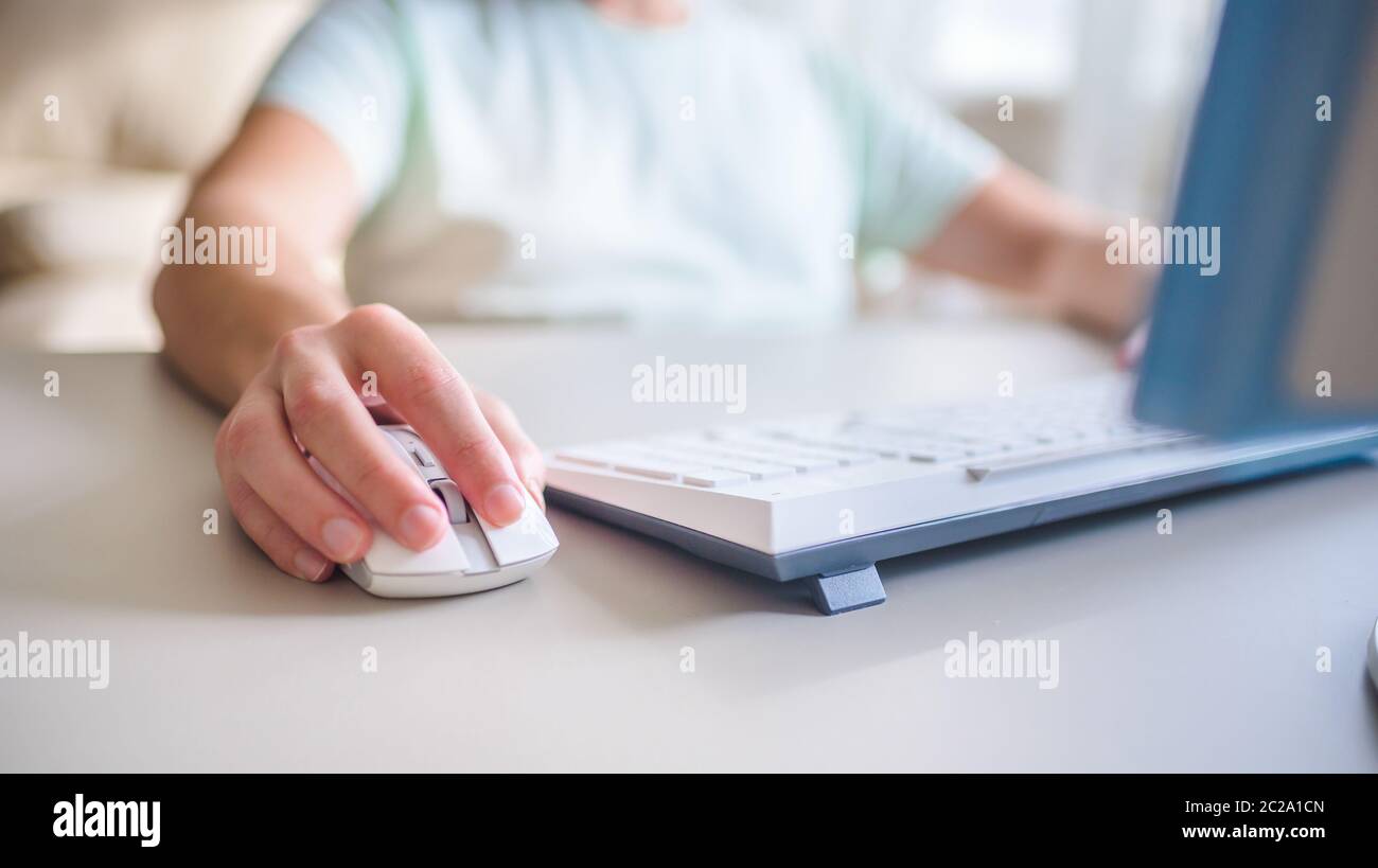 the developer works at computer, uses the mouse Stock Photo