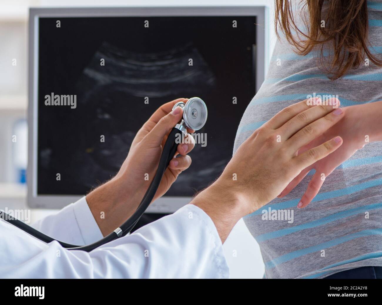 Pregnant woman visiting doctor for regular check-up Stock Photo