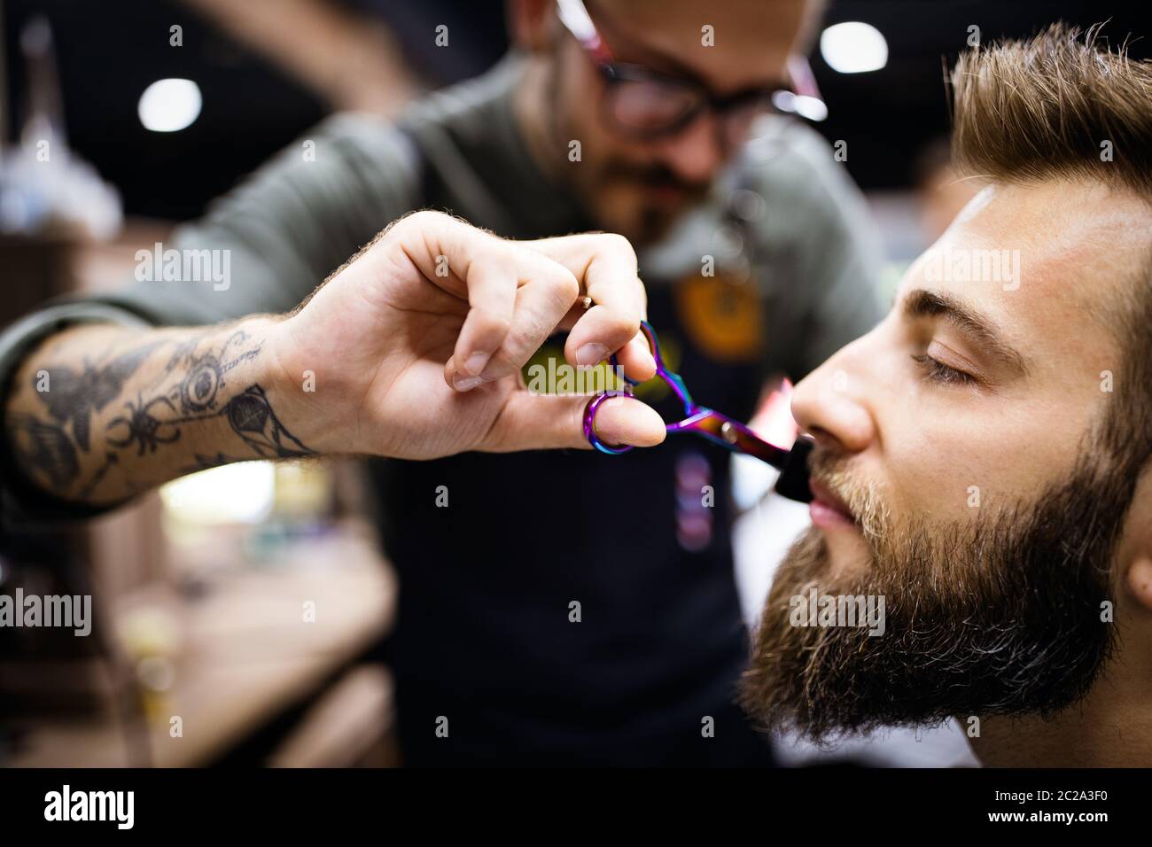 Client during beard and moustache grooming in barber shop Stock Photo Alamy