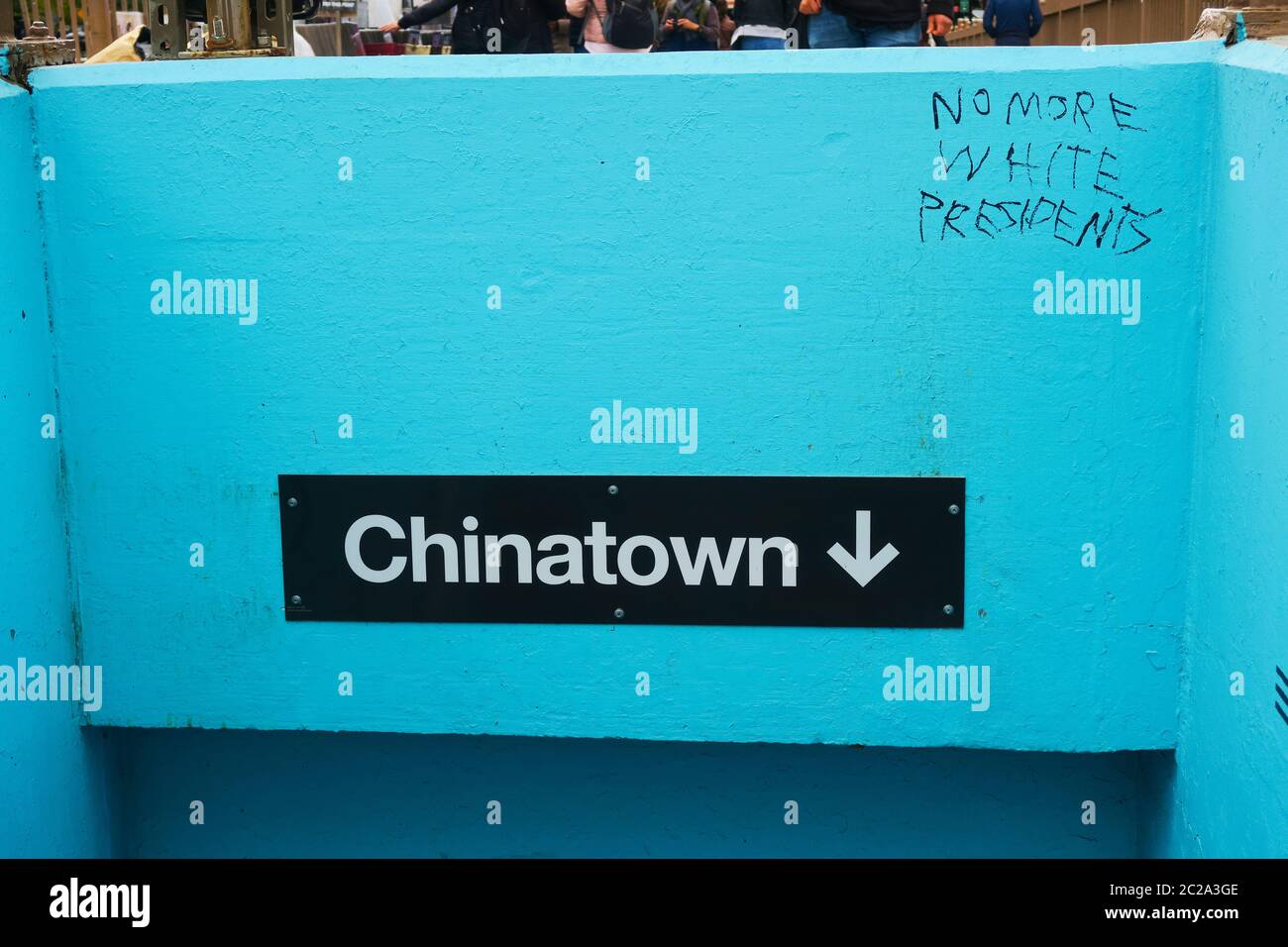 Chinatown sign in New York with racist graffiti. Stock Photo