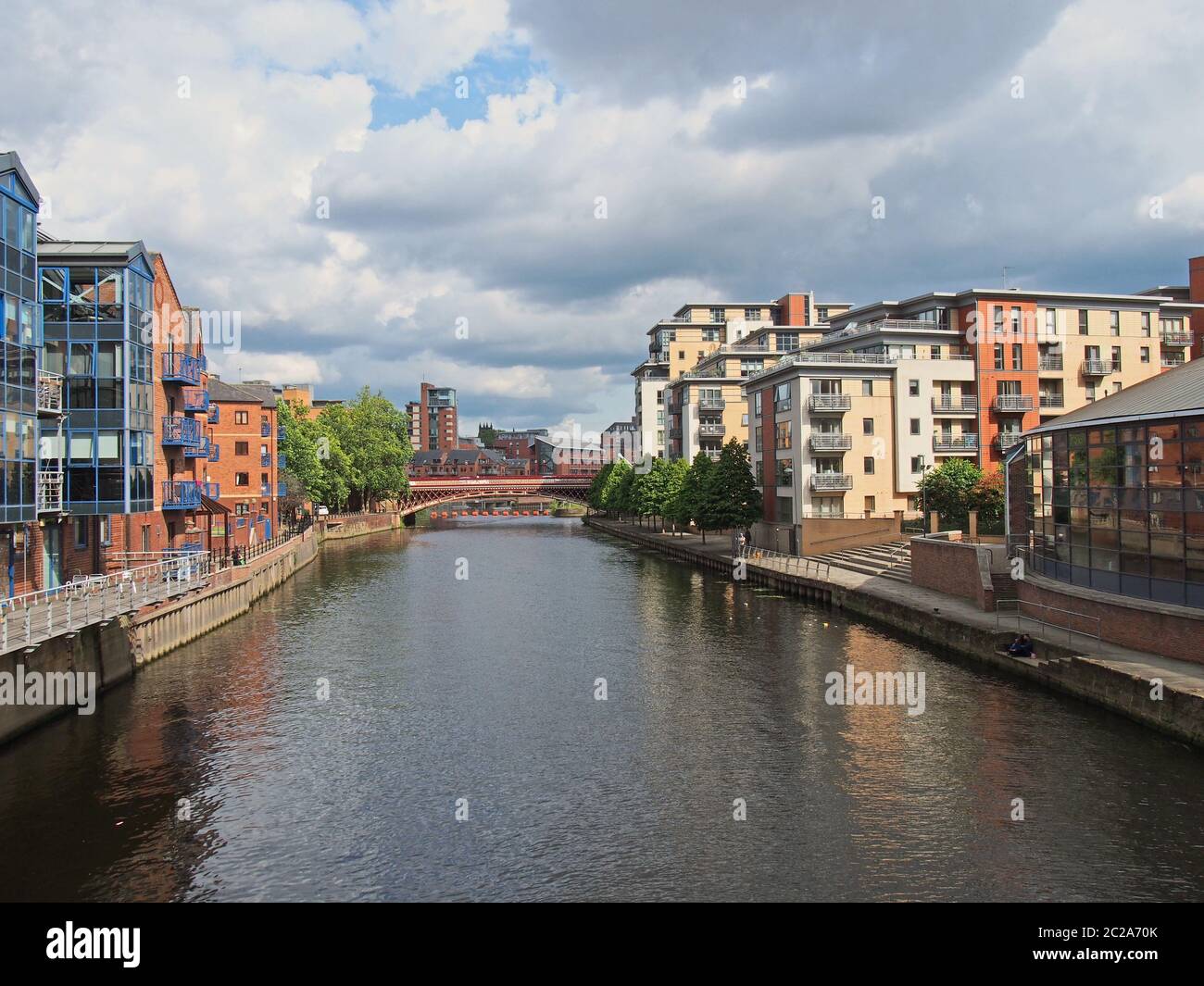 a view along the river aire in leeds with waterside apartments and buildings with crown point bridge in the distance Stock Photo