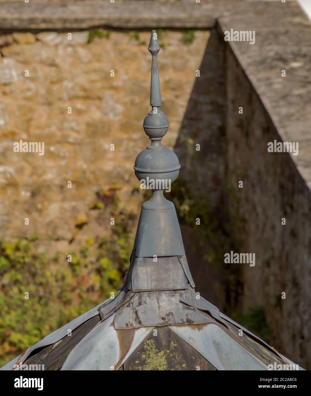 Pointed ifuid plomb on the roof of a porticist of entry in Belgium Stock Photo