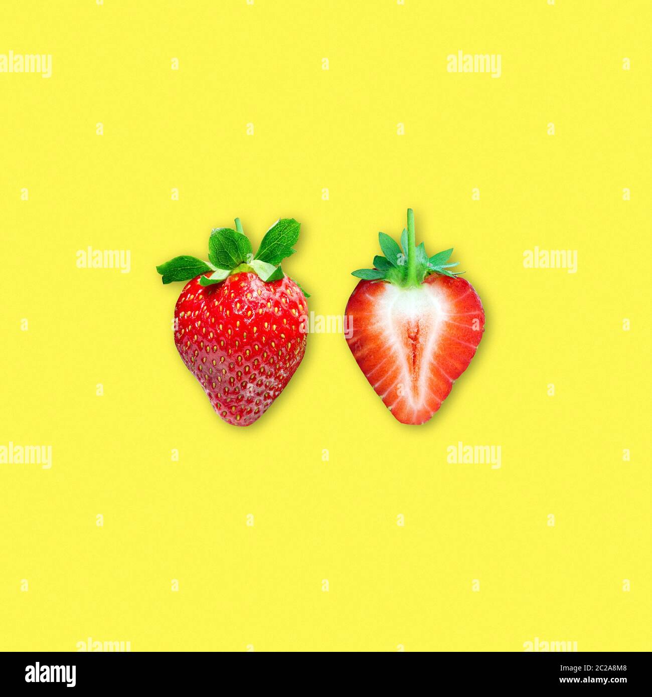 Ripe strawberry and sliced strawberry isolated on yellow background ...