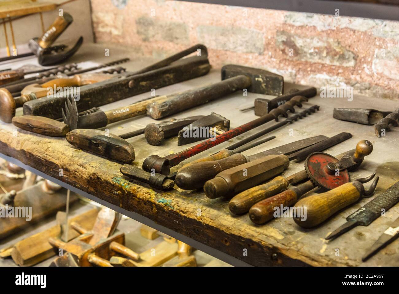Collection of vintage woodworking tools on a rough workbench and blank copy space: carpentry Stock Photo