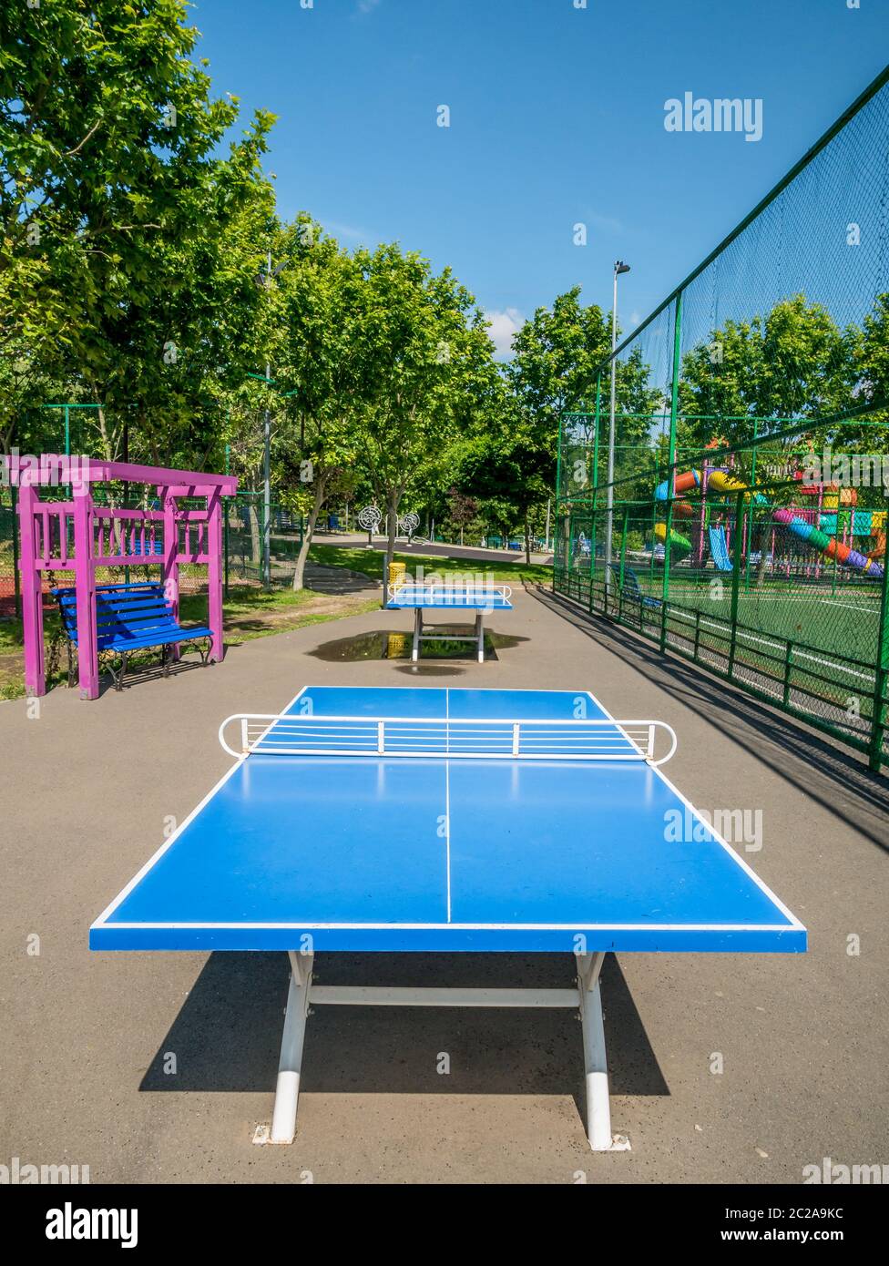 Empty park with blue ping pong table or tennis tables Stock Photo - Alamy