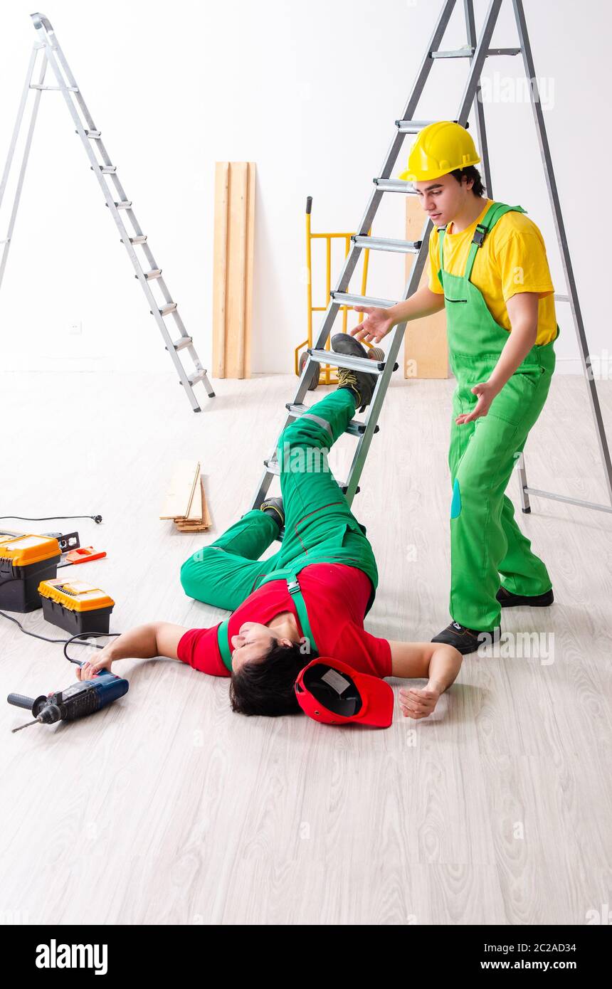 Injured worker and his workmate Stock Photo