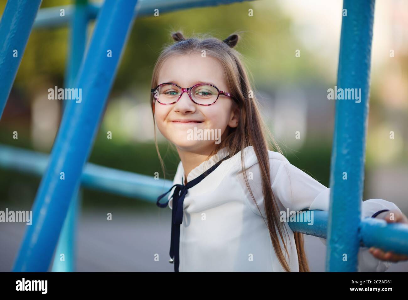Happy child girl on the playground. Portrait of smiling schoolgirl ...