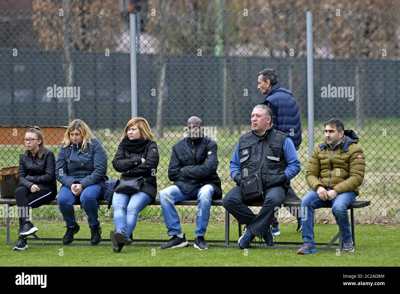 Parents watching and supporting kids soccer match, in Milan. Stock Photo