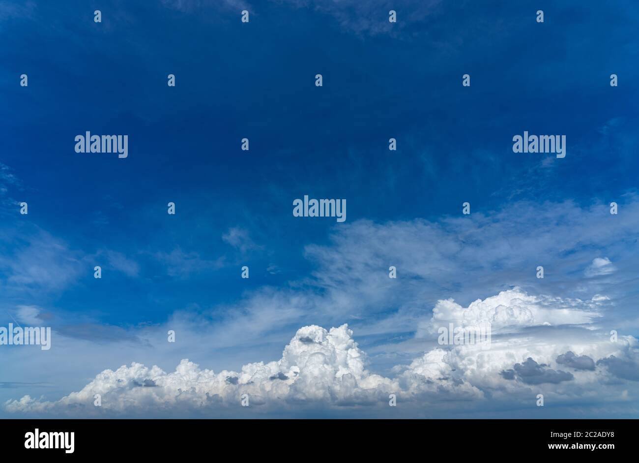 Vast white cumulus clouds with blue sky background Stock Photo