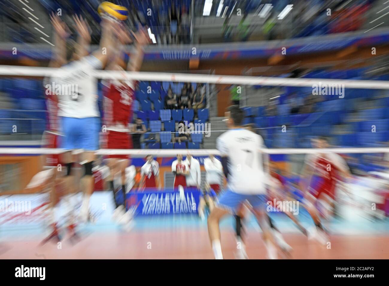 Indoor volleyball players in action, during the international Volleyball Nations League match, Poland vs Argentina, in Milan. Stock Photo