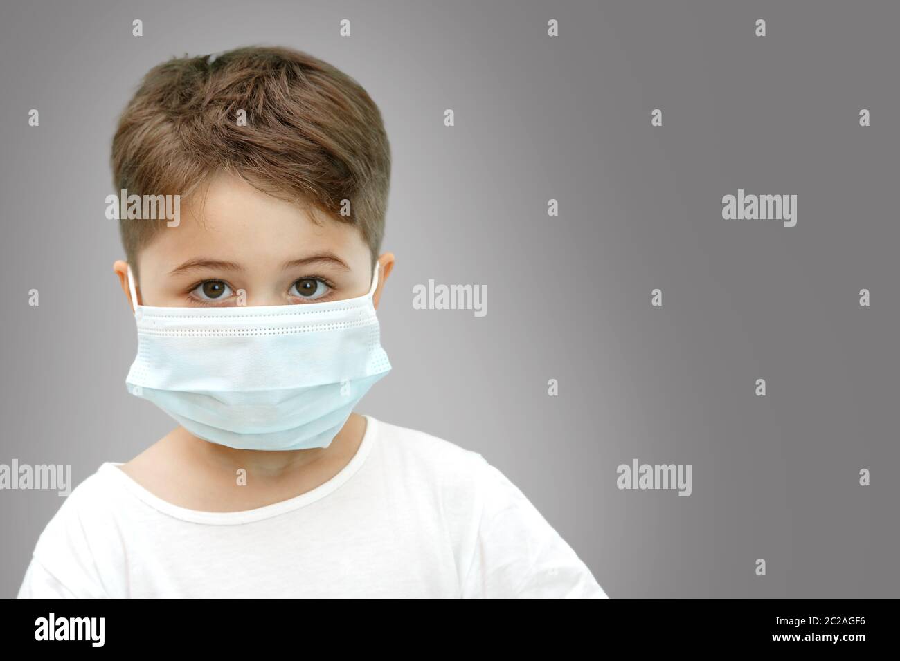 little Caucasian boy in medical mask on isolated background Stock Photo ...