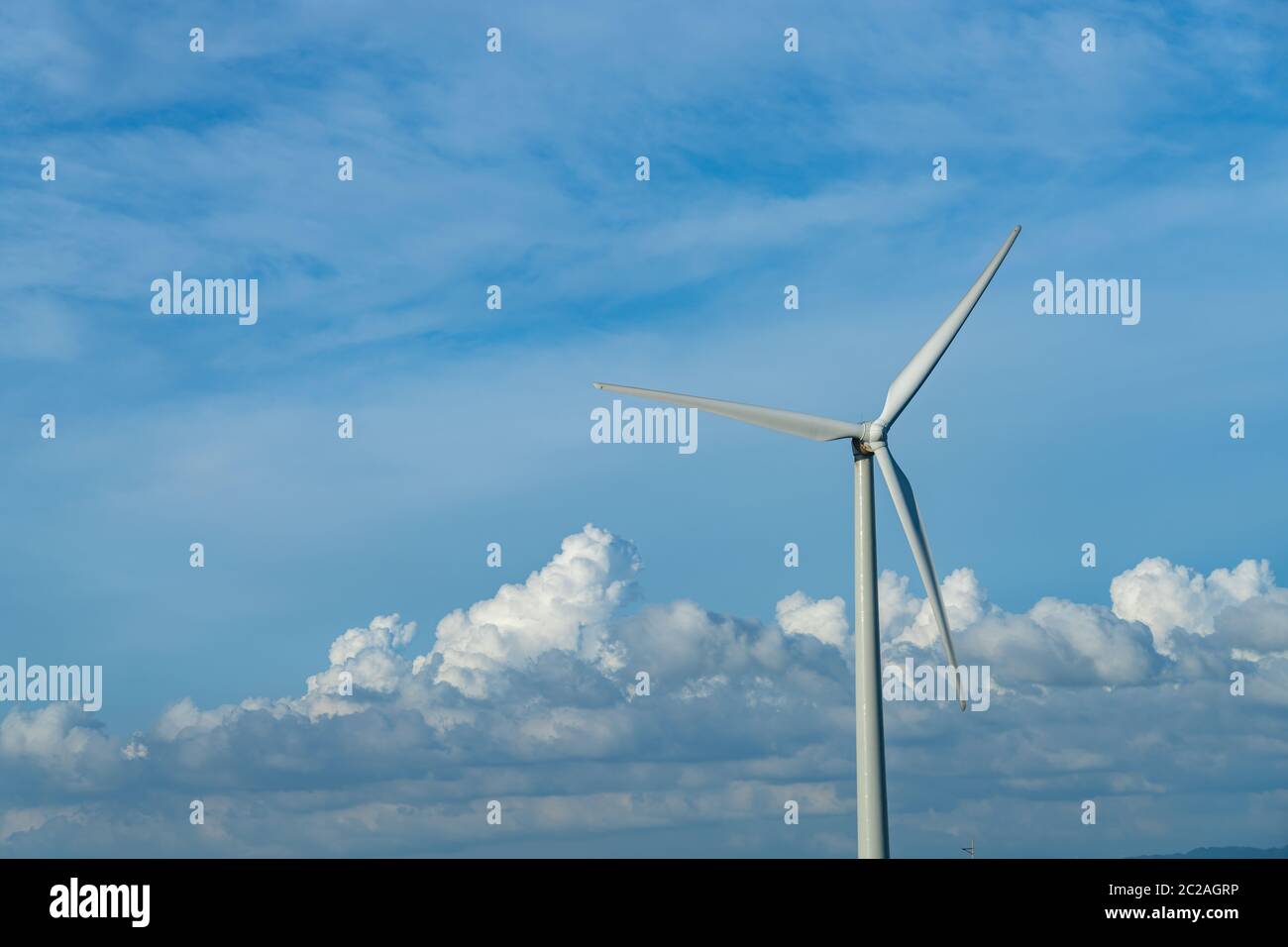 Close-up wind turbines or wind energy converter in sunny day with blue ...