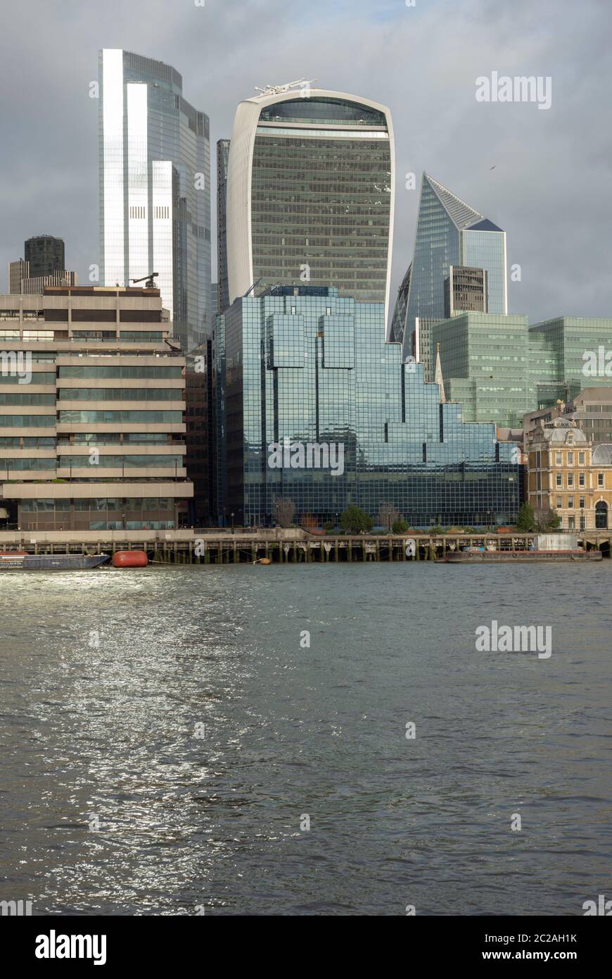City of London skyscrapers and the 22 Bishopsgate or The Twentytwo building glass facade reflections in the River Thames London UK as of January 2020 Stock Photo