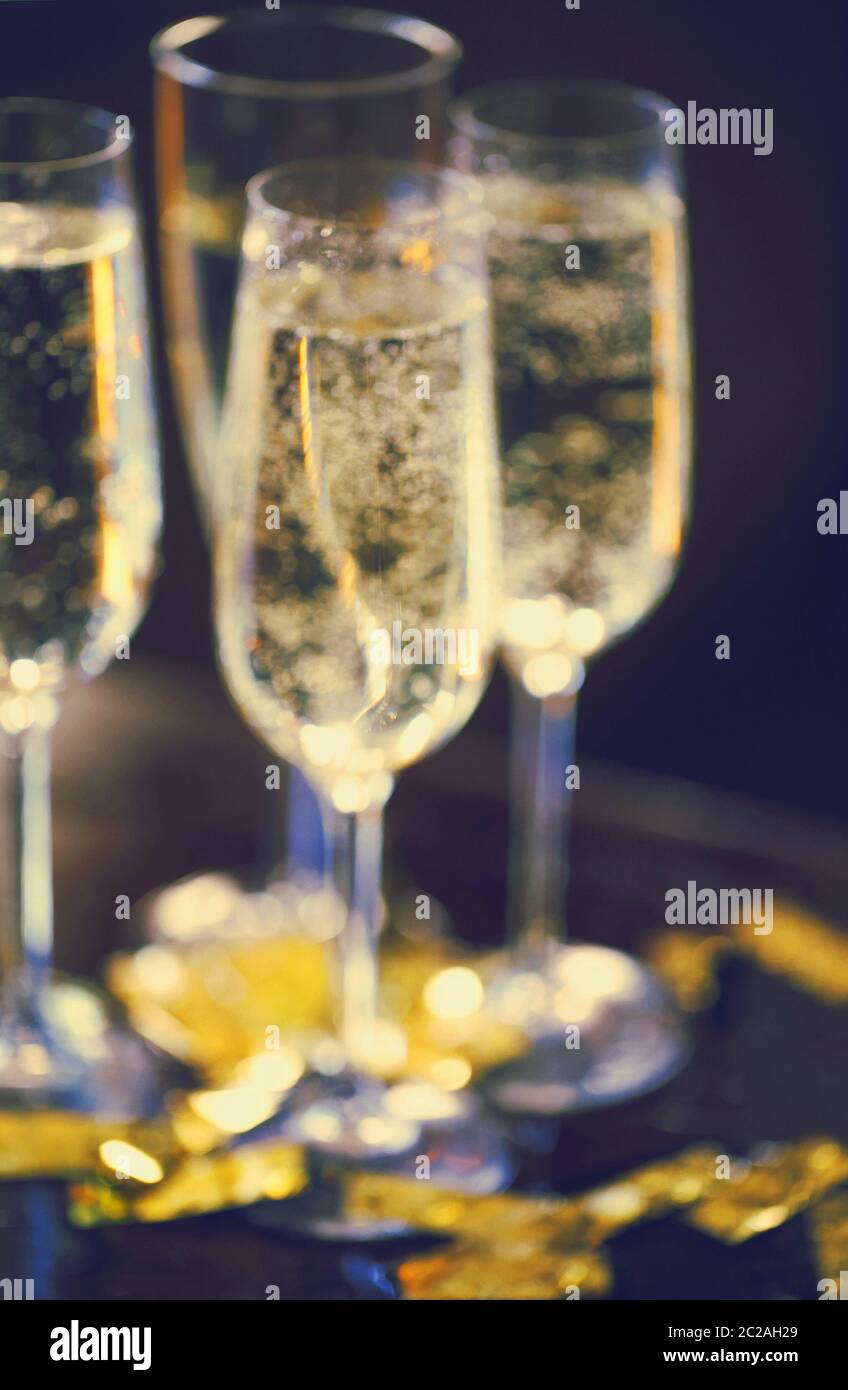 Champagne Flutes In Golden Sparkle Background with golden confetti