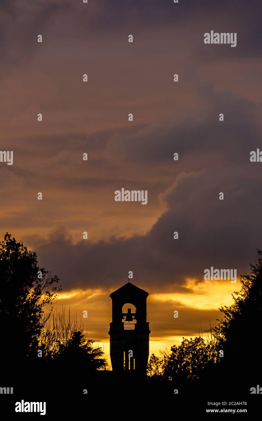 Beautiful sunset clouds over an old bell tower (with copy space above) Stock Photo