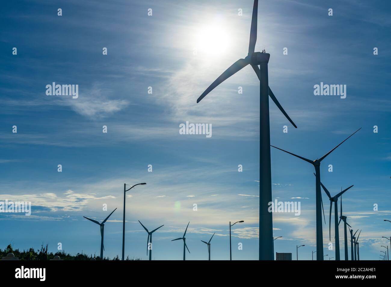 Close-up wind turbines or wind energy converter in sunny day with blue ...
