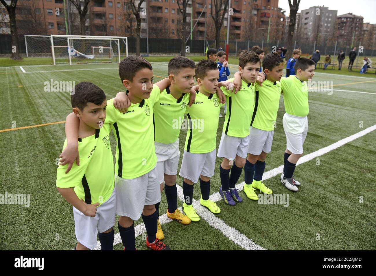 kids soccer teammates embrace each other during penalty kicks, in Milan. Stock Photo