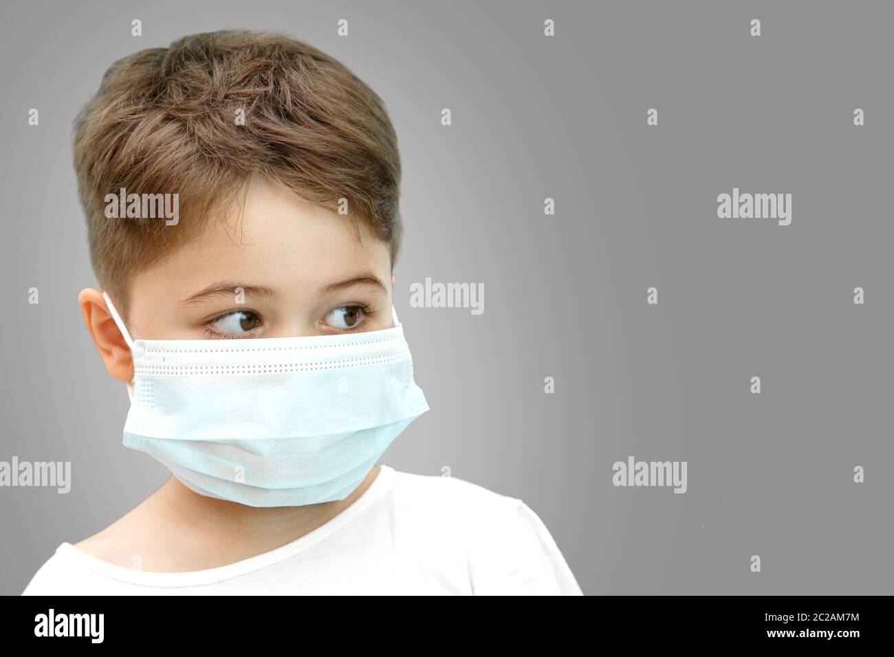 little Caucasian boy in medical mask on isolated background Stock Photo ...