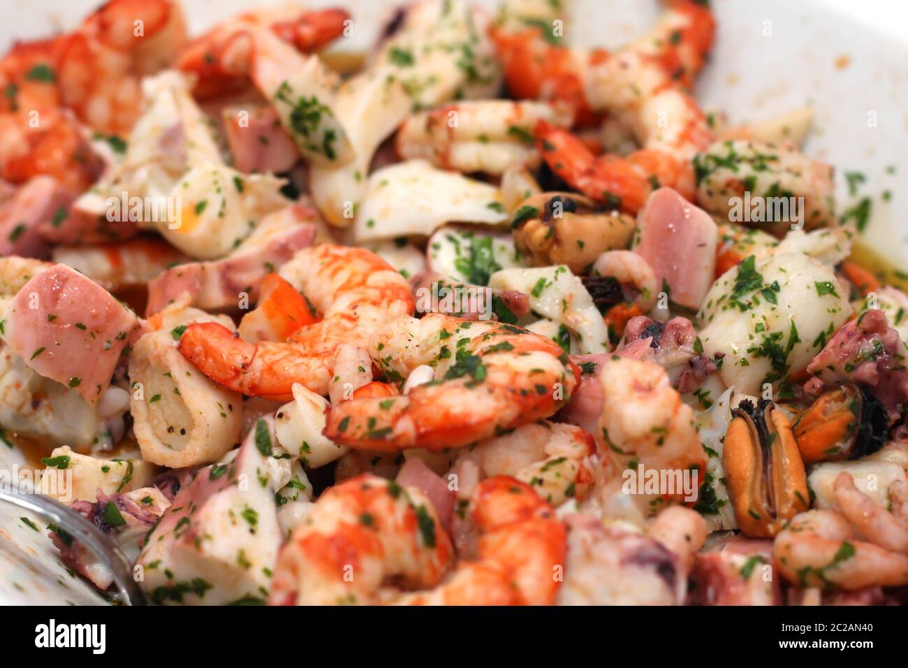 rich and mixed seafood salad on a serving plate Stock Photo