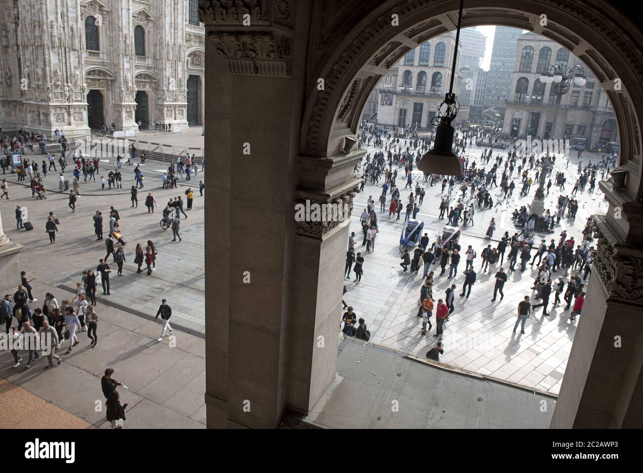 top view of pedestrians walking on Duomo sqauer, seen through the gallery arcade, in downtown Milan. Stock Photo