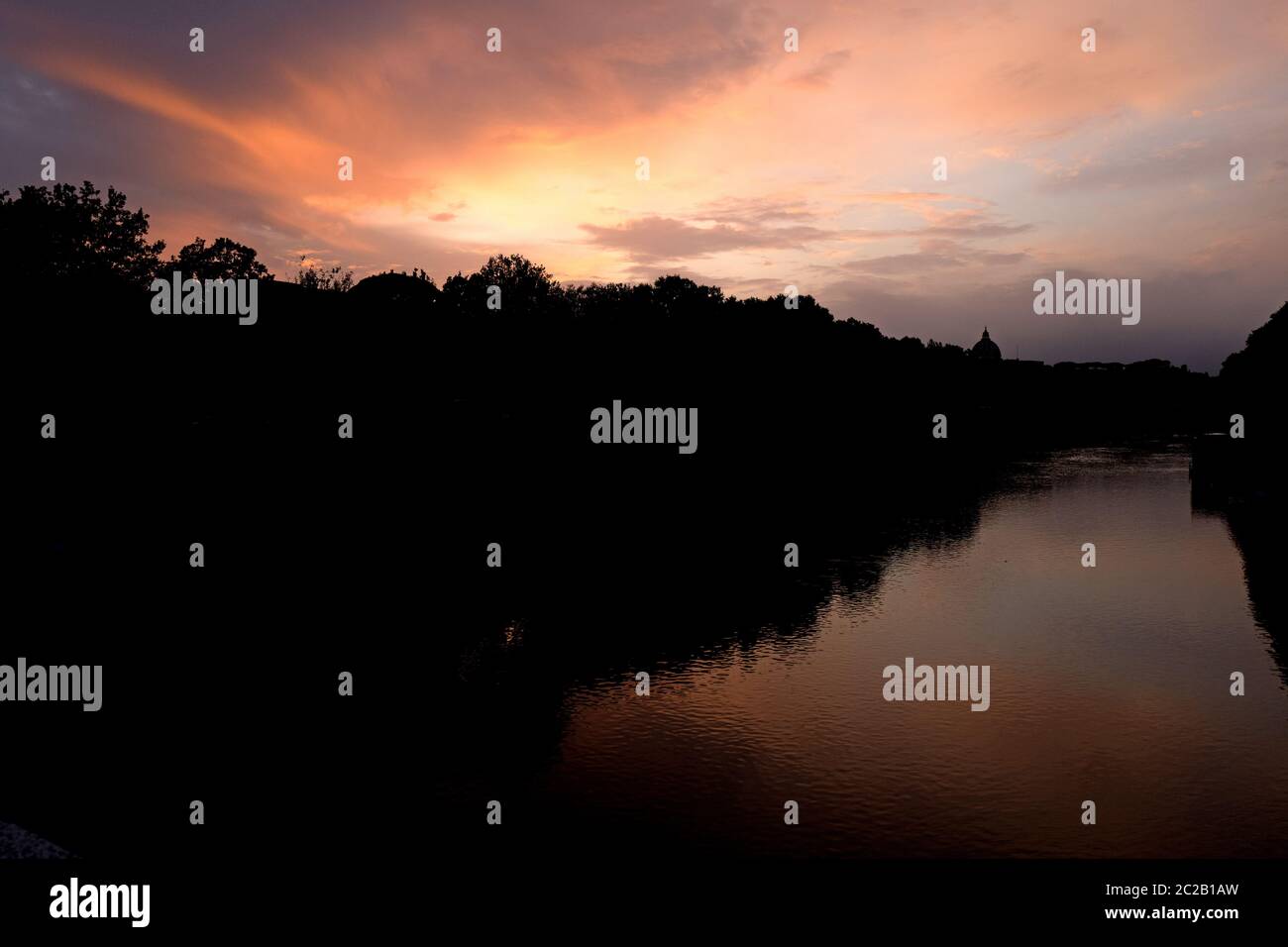 Sunset's sky reflected on Tiber river of Rome, Italy Stock Photo