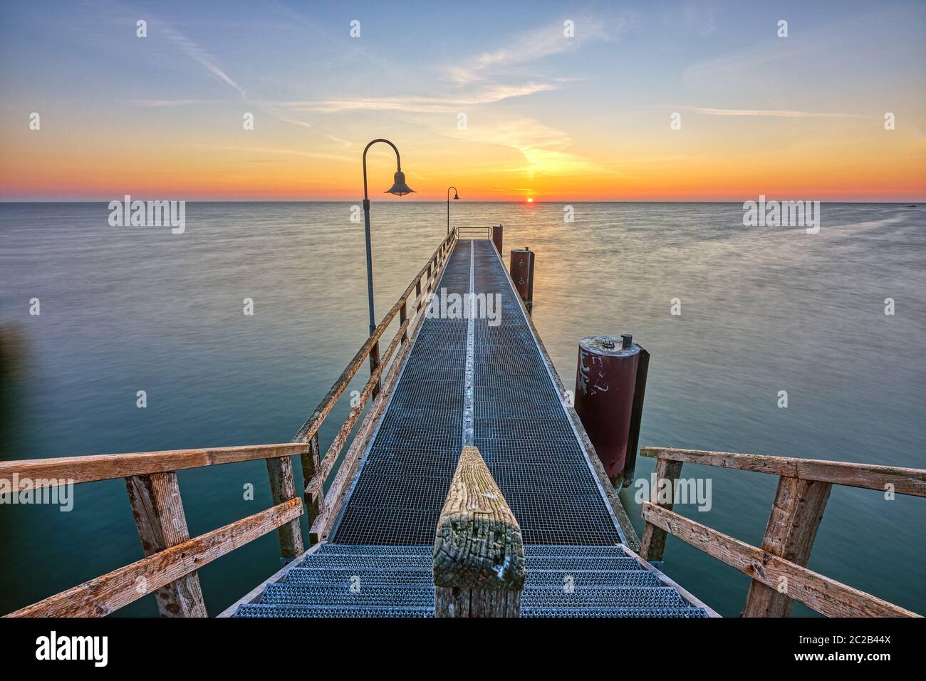Sunrise at a pier on the german Baltic Sea coast Stock Photo