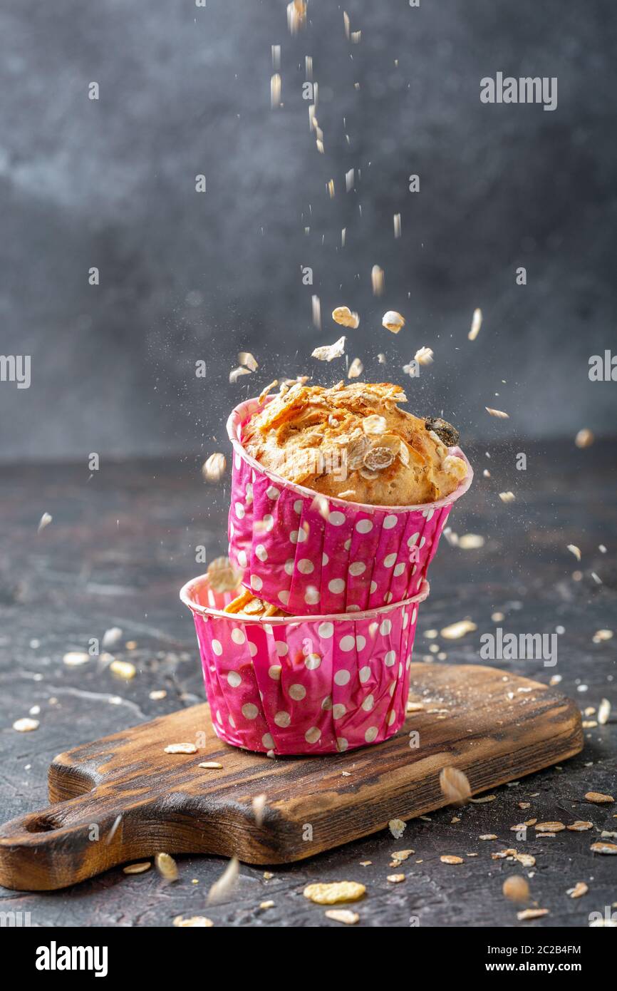Muffins with pears and muesli in pink paper forms. Stock Photo