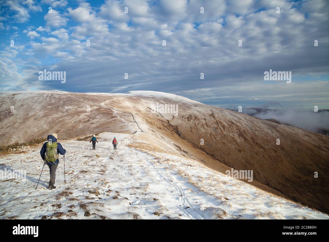 Walkers on the ridge to Merrick, the highest mountain in the Southern Uplands, Galloway Hills, Dumfries & Galloway, Scotland Stock Photo