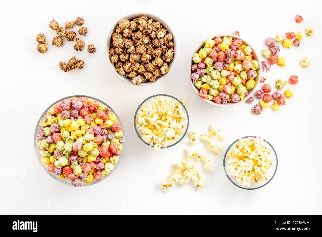 Flavored popcorn on white table top view Stock Photo
