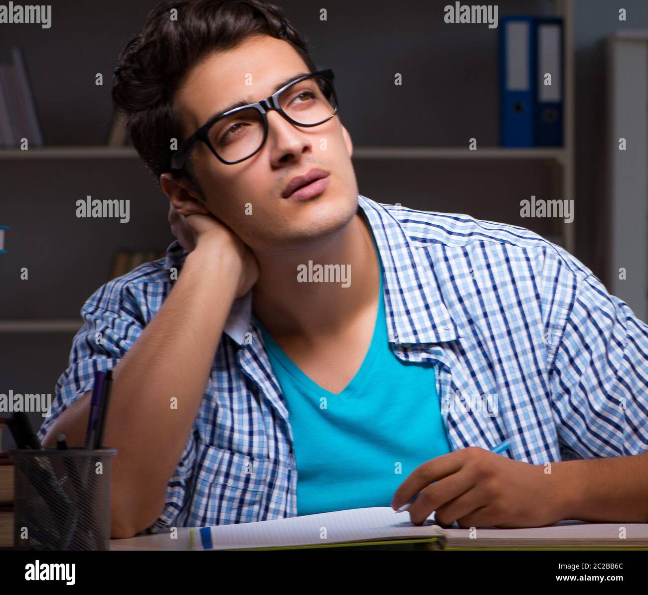 Student preparing for exams late night at home Stock Photo - Alamy