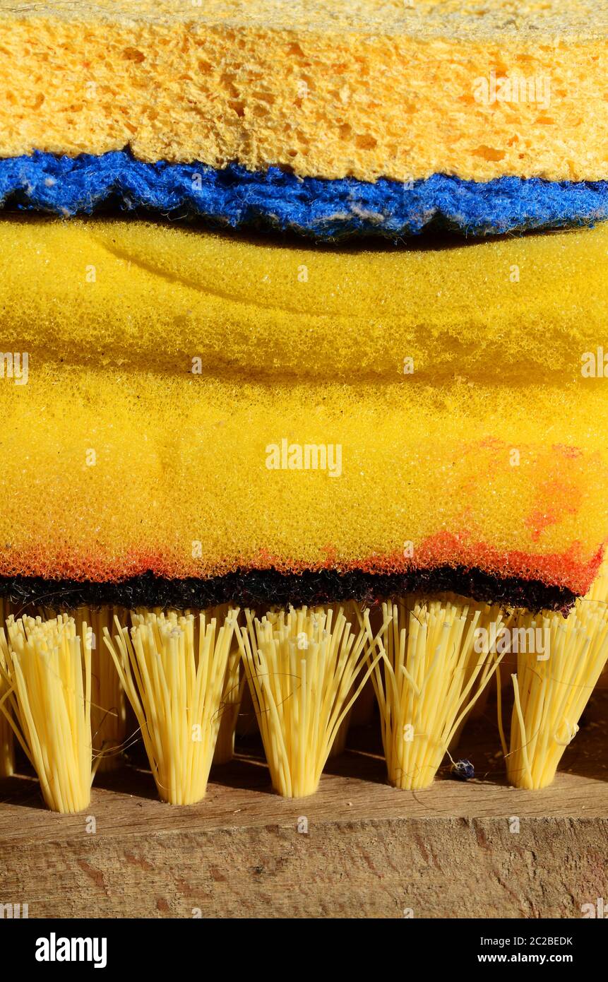 Cleaning supplies in yellow with sponge and brush for house work Stock Photo