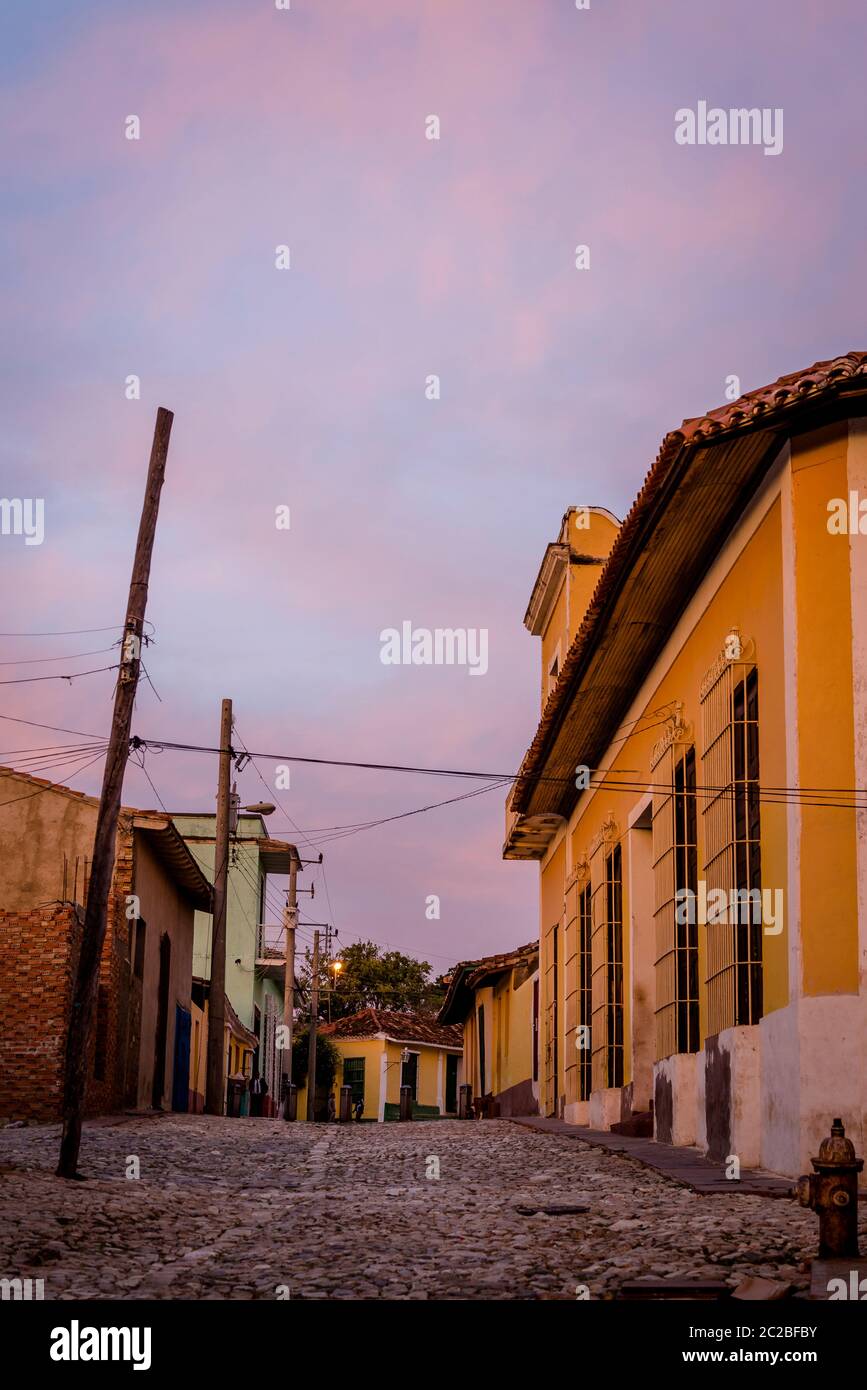 Empty cobblestone street and quaint Spanish style colonial architecture in a residential neighbourhood of the city centre, Trinidad, Cuba Stock Photo