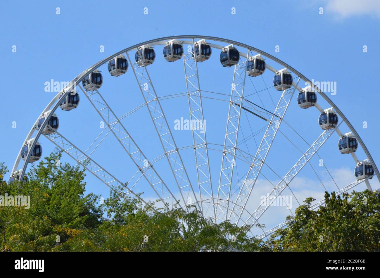 Budapest, Hungary, 29th, August, 2014 - Budapest Eye (Erzsébet tér) landscape through the tree branches in Elizabeth Square. Stock Photo